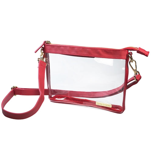 This is a Capri Designs clear stadium bag with a removable strap and red leather accents.